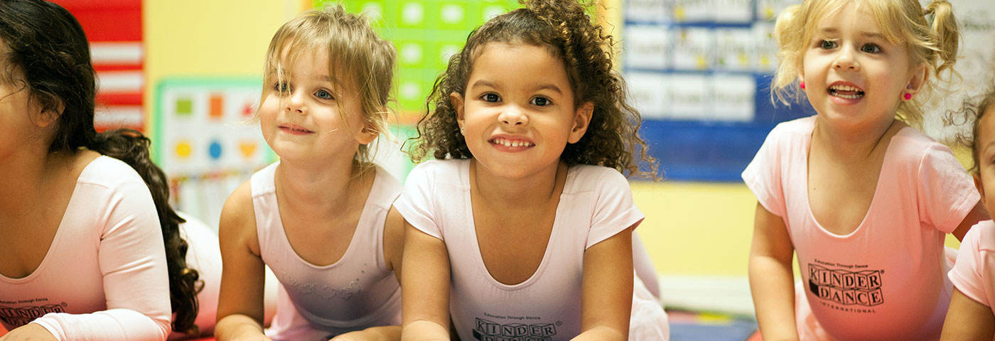 girls playing on a mat in room